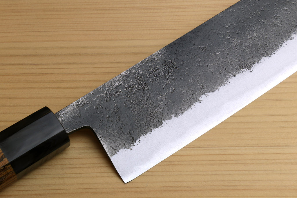Japanese nakiri knife blade close-up with dark collar and silver edge