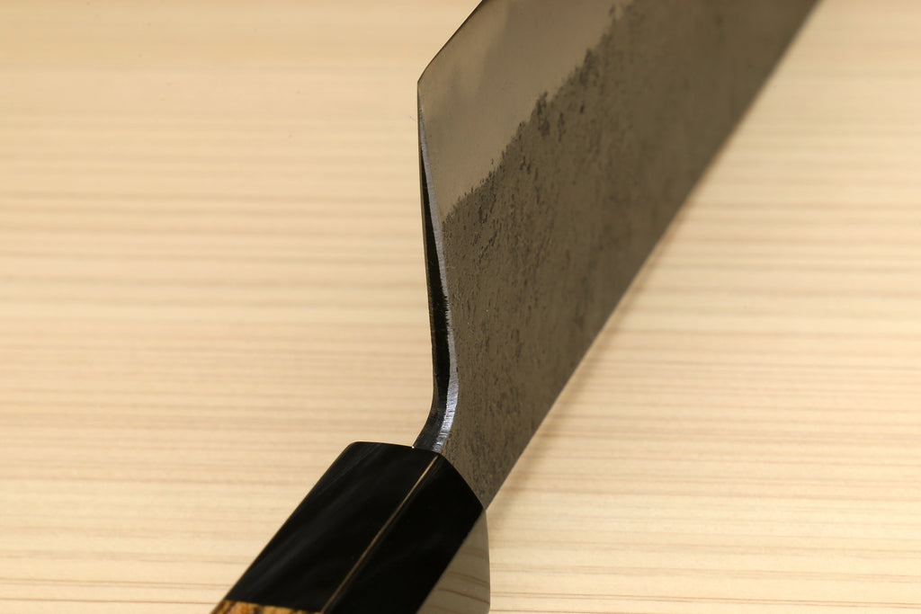 Japanese nakiri knife with curved spine, dark handle, and silver textured steel blade