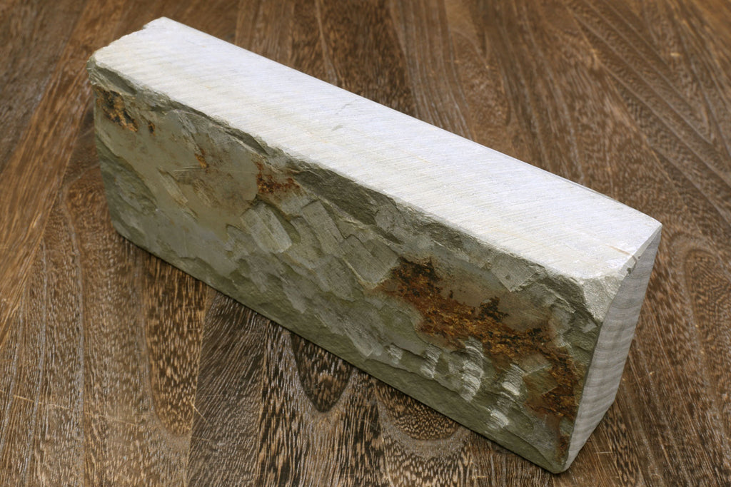 Natural sharpening whetstone block, pale white top with green-gray sides