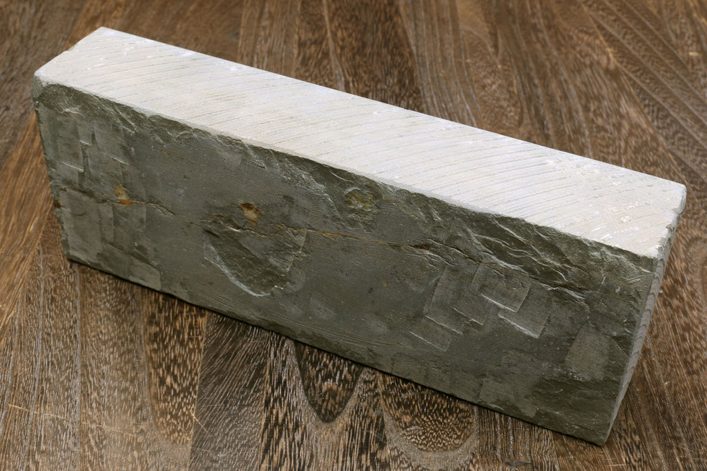 Sharpening whetstone rectangular stone block with white face and dark sides
