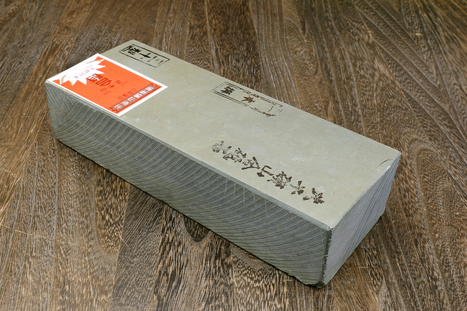Natural whetstone finishing stone in box packaging, rectangular gray block