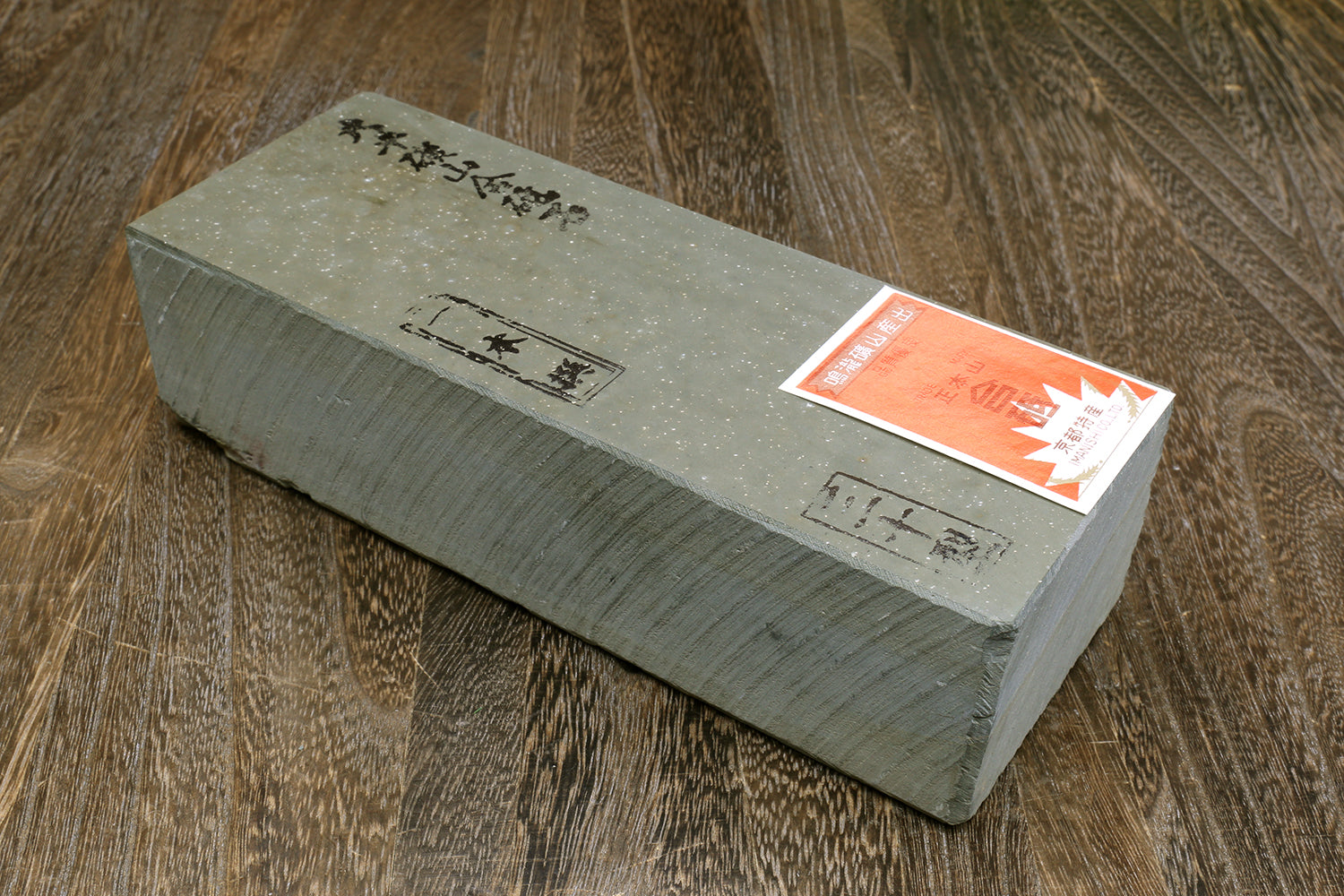 Natural sharpening whetstone block with orange label stickers on side