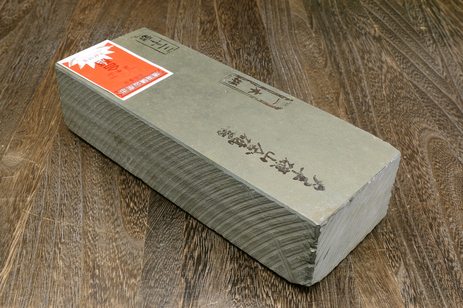 Natural sharpening whetstone, rectangular gray-green stone block with printed labels