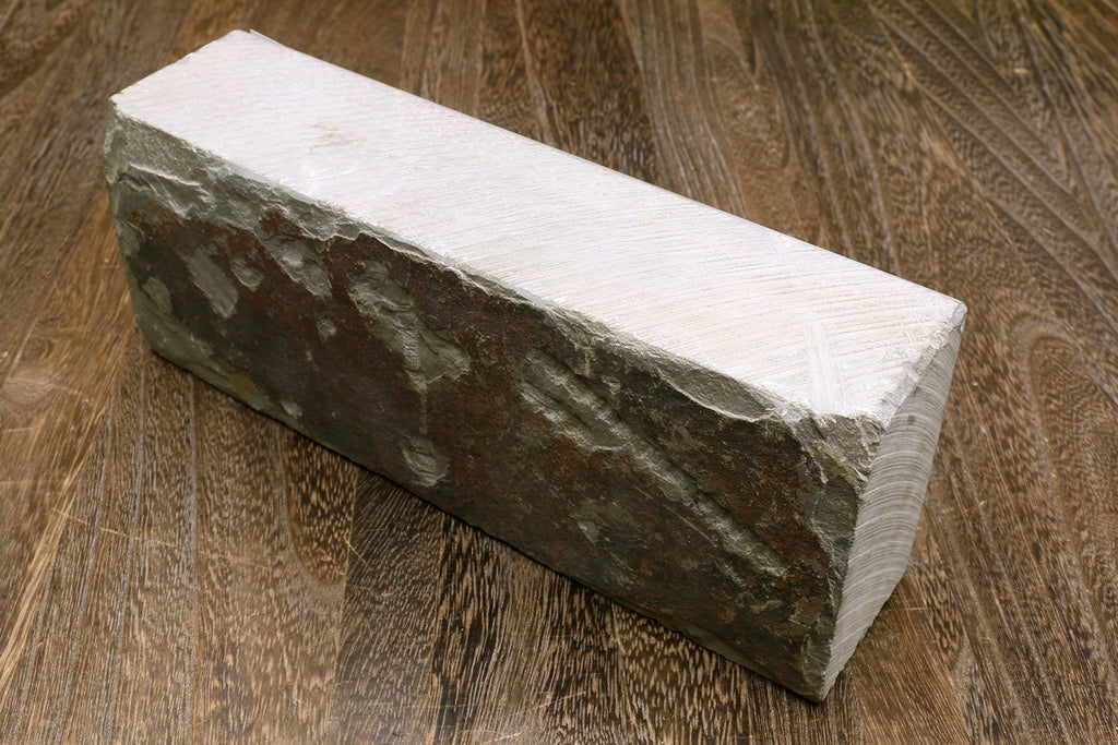 Natural sharpening whetstone, dark green rectangular stone with light top surface