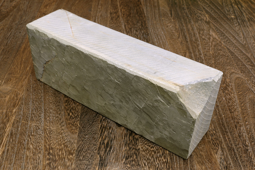 Natural sharpening whetstone, rectangular white top with dark gray sides