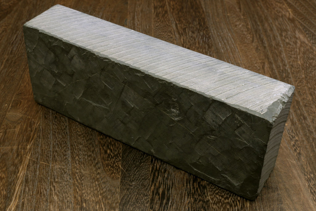 Natural whetstone sharpening stone, dark green rectangular block with pale side