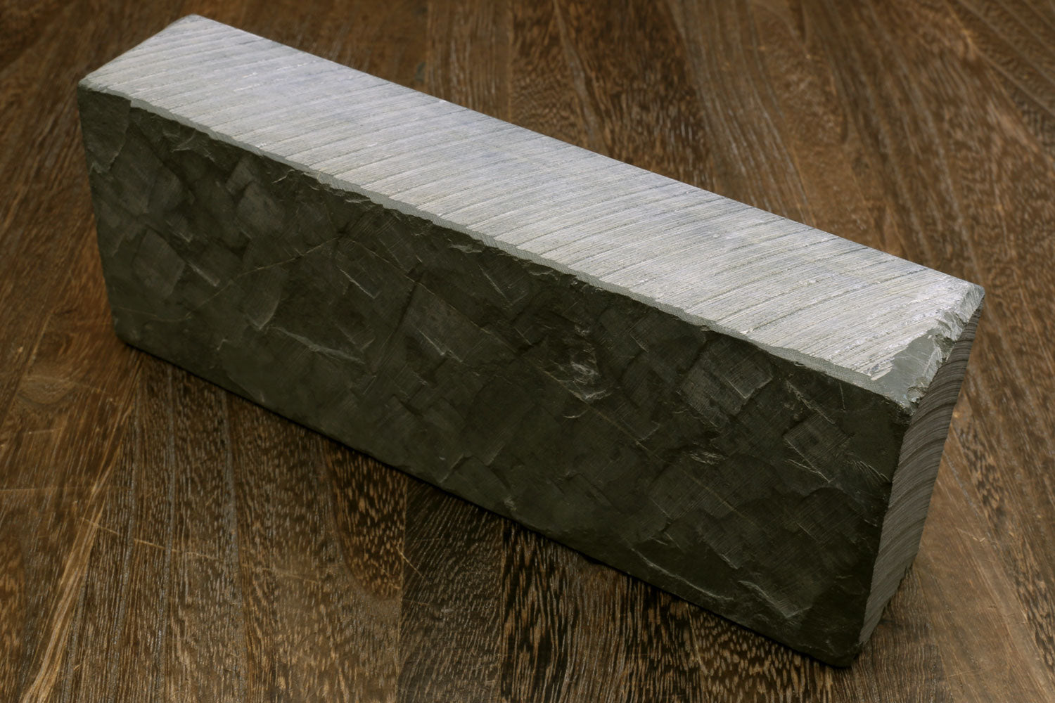 Natural whetstone sharpening stone, dark green rectangular block with pale side