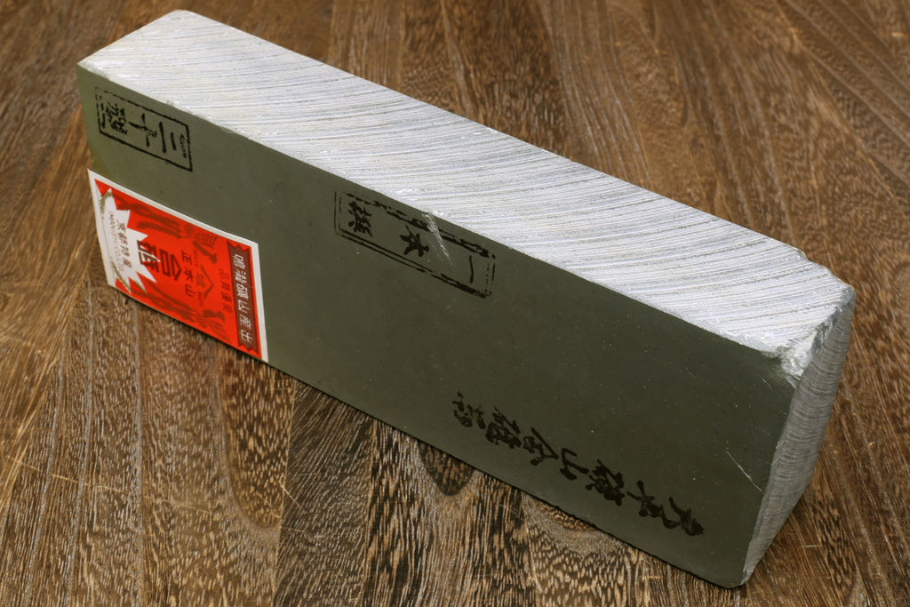Natural sharpening whetstone block with printed label panel and light stone face