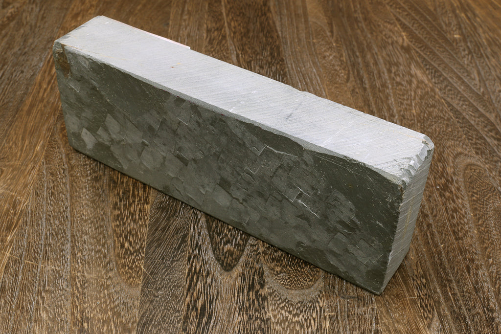 Natural sharpening whetstone, dark green rectangular stone with light top surface