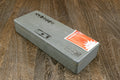 Natural sharpening whetstone with Japanese markings and orange label on one face