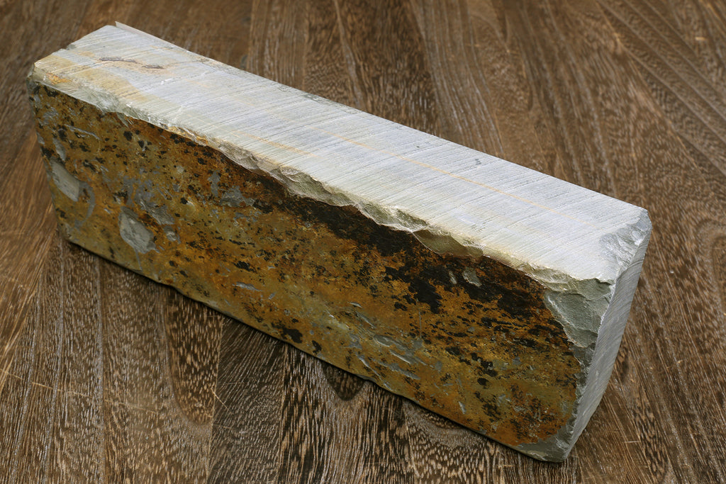 Natural sharpening whetstone, speckled brown side with pale white edges