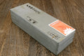 Natural sharpening whetstone, rectangular gray stone with orange label on end