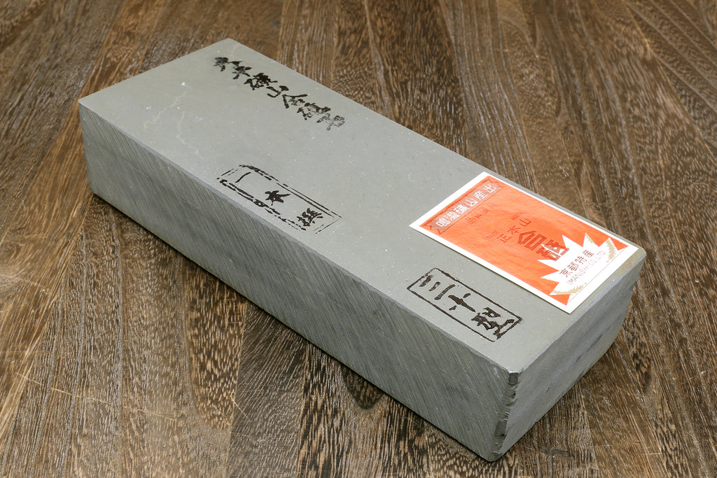 Natural sharpening whetstone, rectangular gray block with white label and diagram