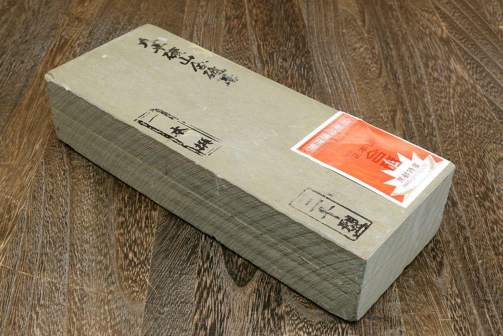Natural sharpening whetstone, cream top with dark gray sides and label