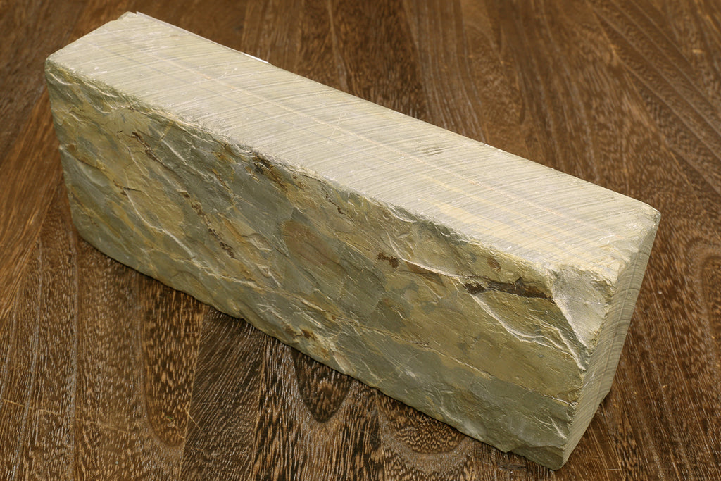 Natural sharpening whetstone, cream block with textured dark green side surface