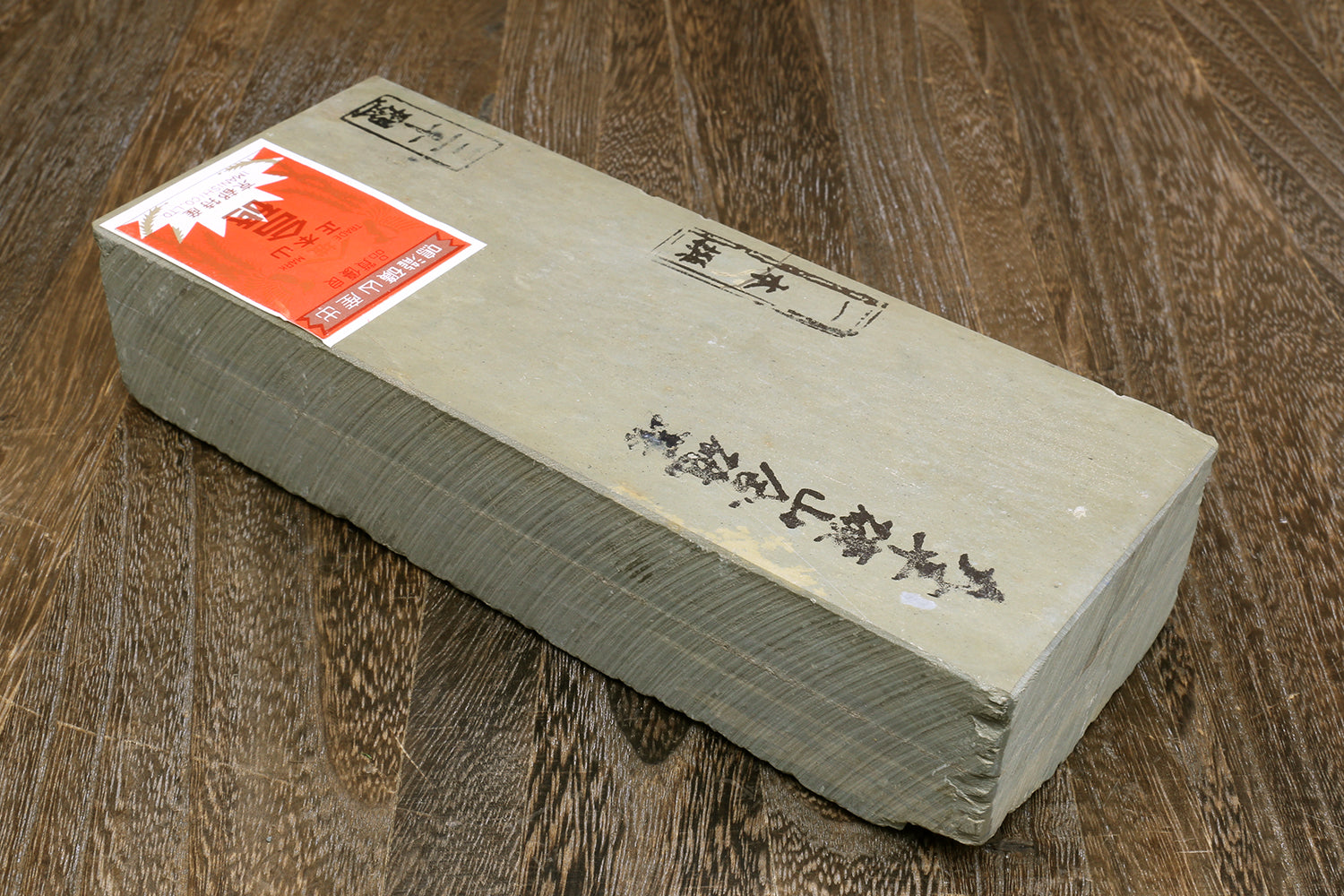 Natural sharpening whetstone, long cream block with orange packaging label on top