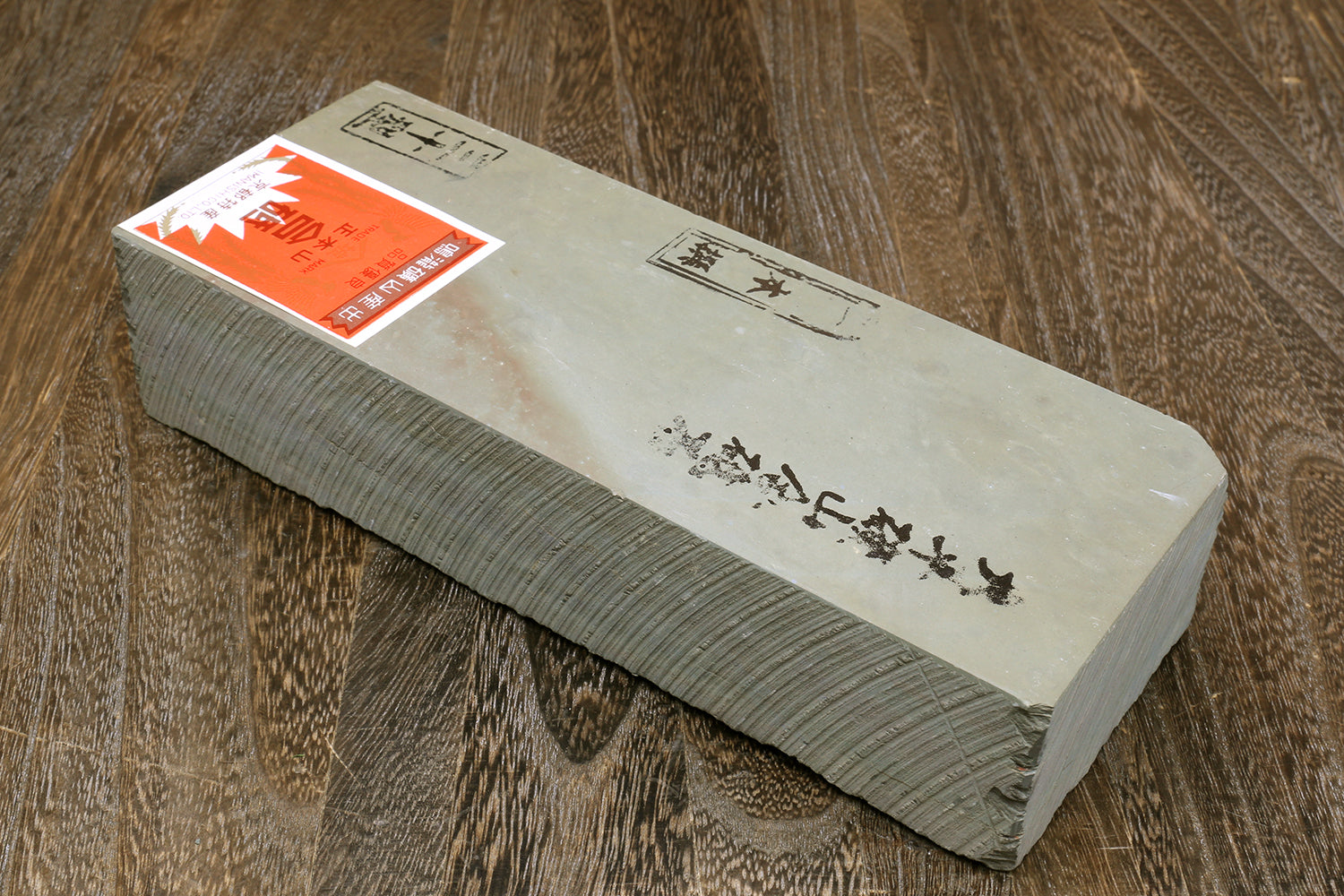 Natural sharpening whetstone block with printed markings and white top, gray sides