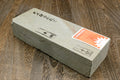 Natural sharpening whetstone block with paper label and white top, gray sides