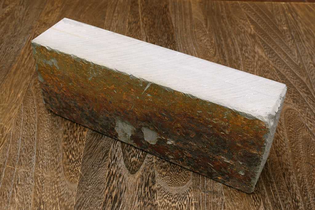 Natural whetstone sharpening stone, gray sides with brown rough edge surface