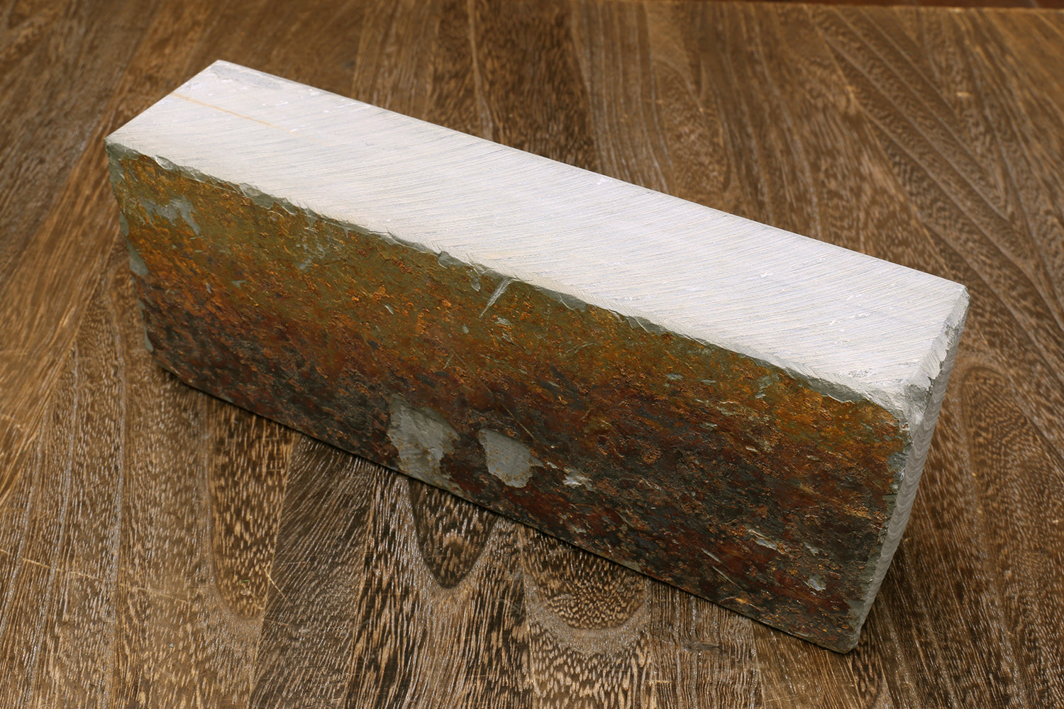 Natural whetstone sharpening stone, gray sides with brown rough edge surface