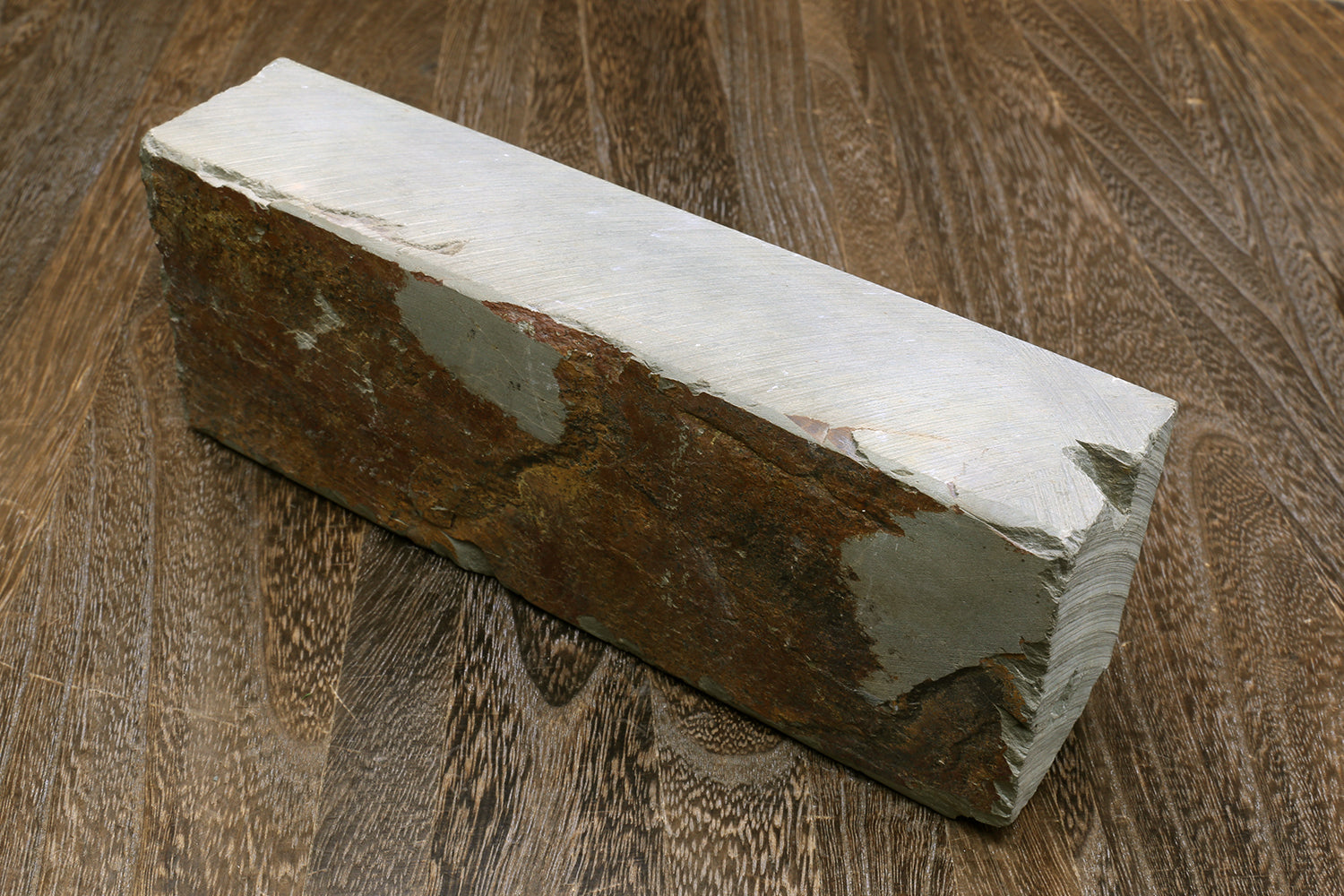 Natural sharpening whetstone block, light gray with dark mottled sides