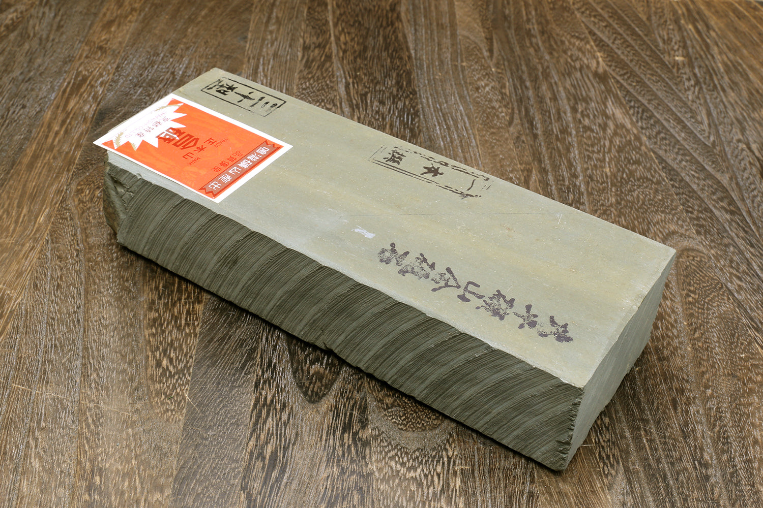 Natural sharpening whetstone in gray wrap, printed label on top