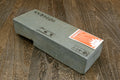 Natural whetstone block, dark gray rectangular stone with label stickers