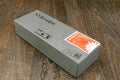 Rectangular gray whetstone with Japanese-style markings and orange sticker