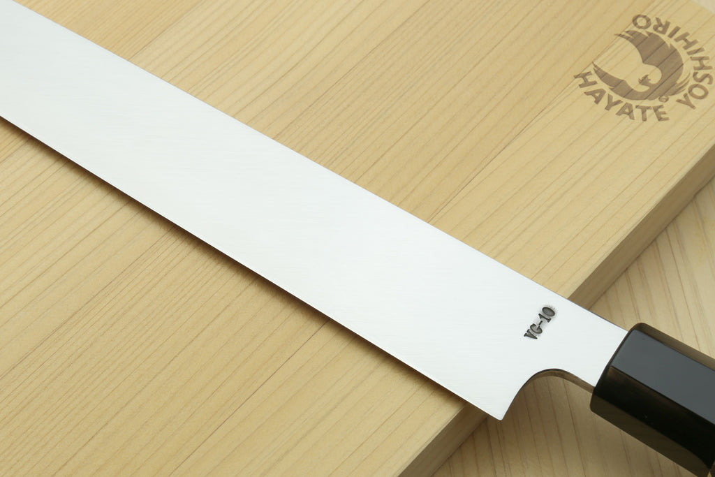 Yoshihiro yanagi sushi knife blade close-up with mirror steel edge and ebony handle