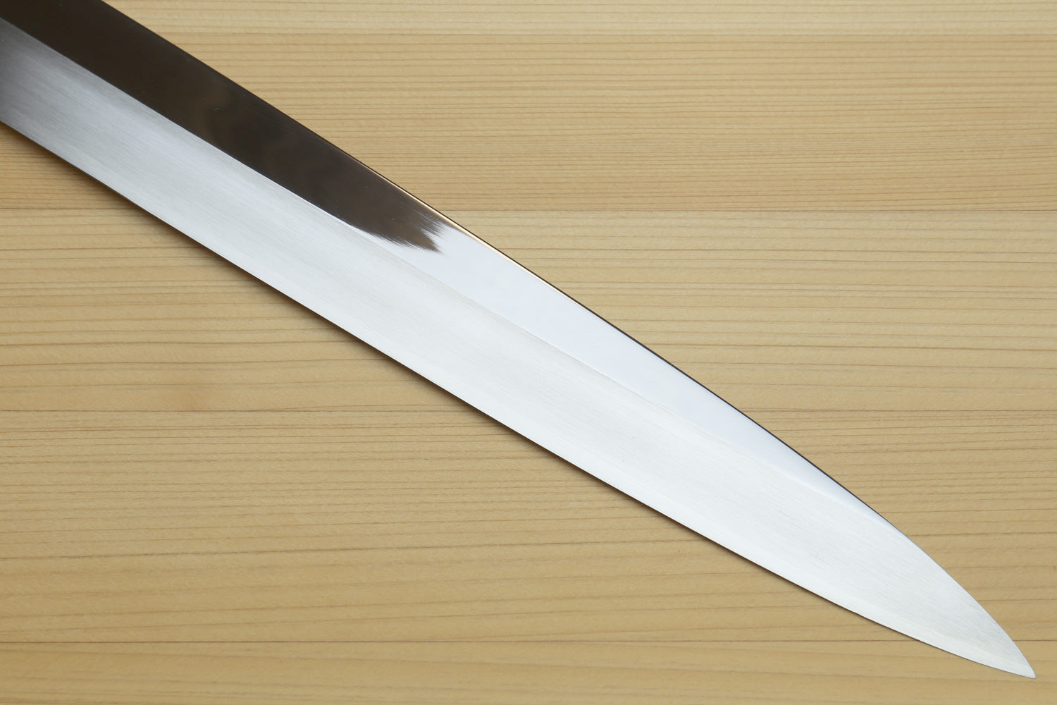 Yoshihiro yanagi sushi knife blade with mirror-finished steel and dark handle