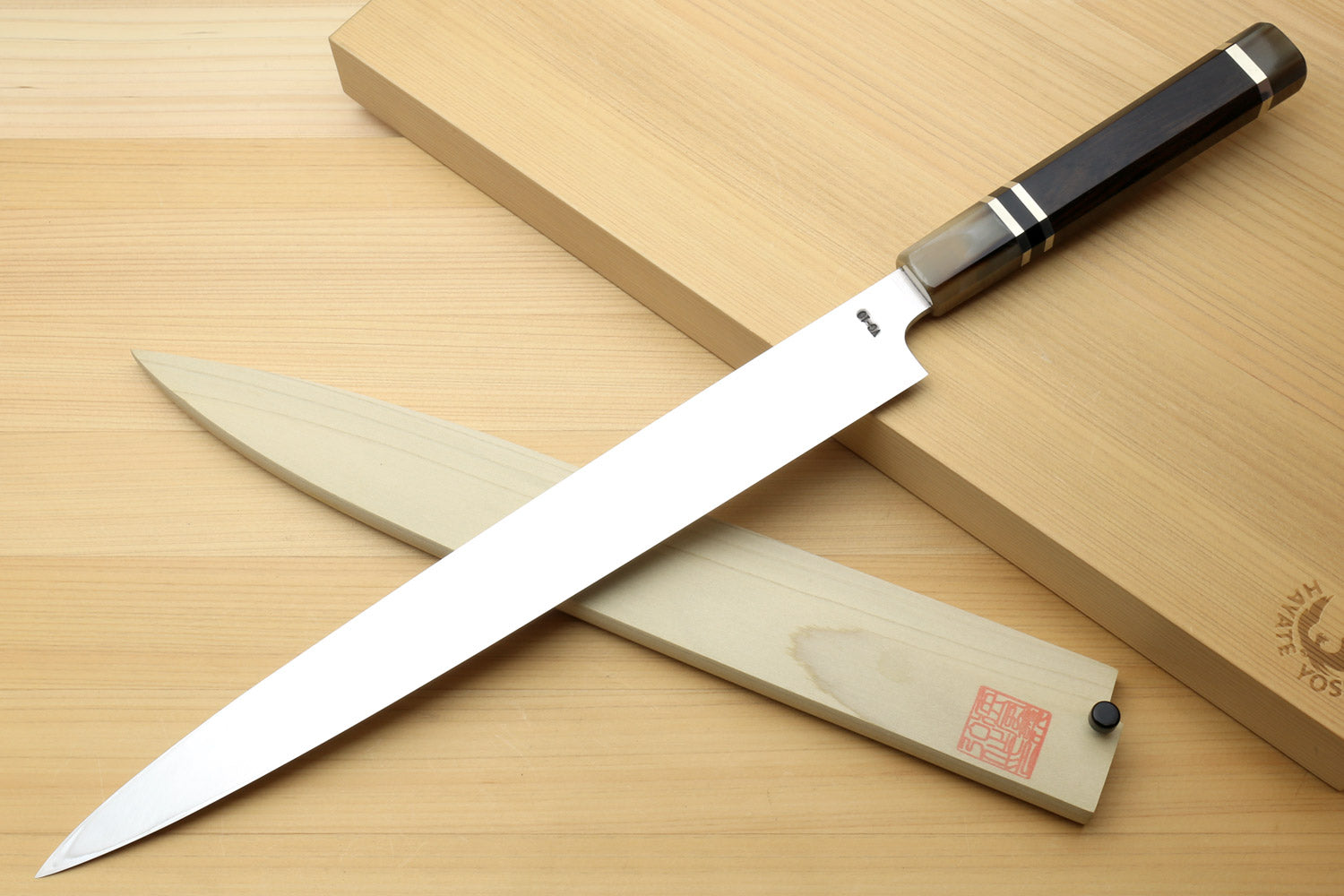 Yanagi sushi knife with mirror blade, black horn bolster, and wooden storage box