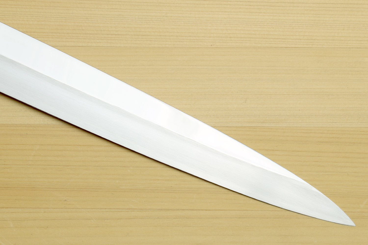 Yanagi sushi knife blade close-up with mirror-finished steel and pointed tip