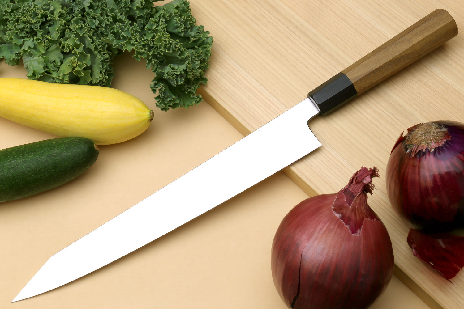 Japanese slicer knife with long silver blade and black bolster, squared heel