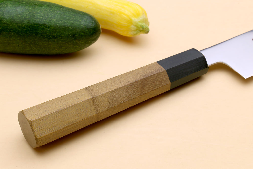 Japanese slicer knife handle close-up with ambrosia wood grip and dark black endcap
