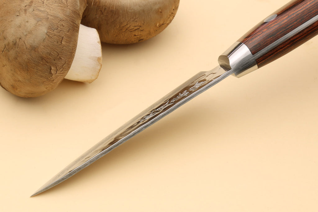 Paring knife angled view, dark brown wood handle with metal bolster and Damascus blade