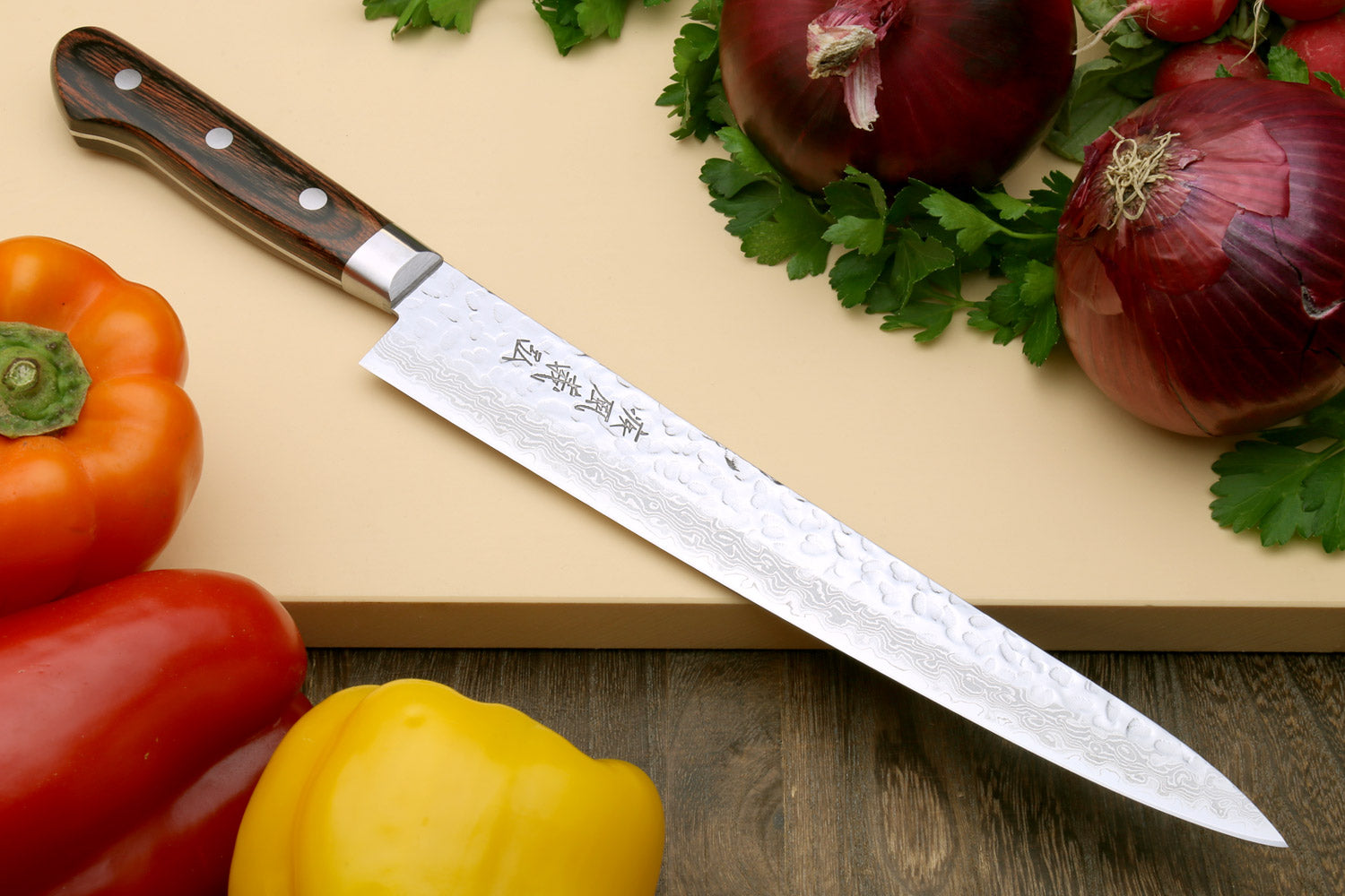 Sujihiki chef knife with hammered Damascus steel blade and dark wooden handle