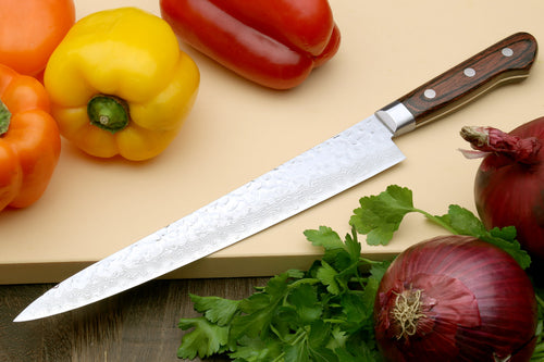 Sujihiki chef knife with pointed hammered Damascus blade and dark wooden handle