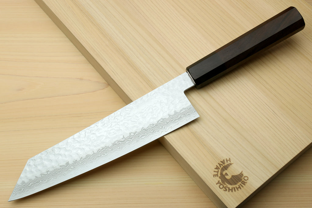 Kiritsuke Japanese chef knife with hammered Damascus blade and octagonal dark wood handle
