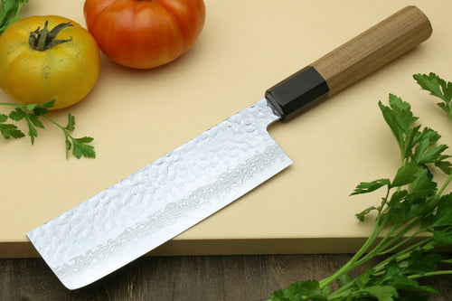 Nakiri vegetable knife with silver hammered blade, wooden handle, and black spacer