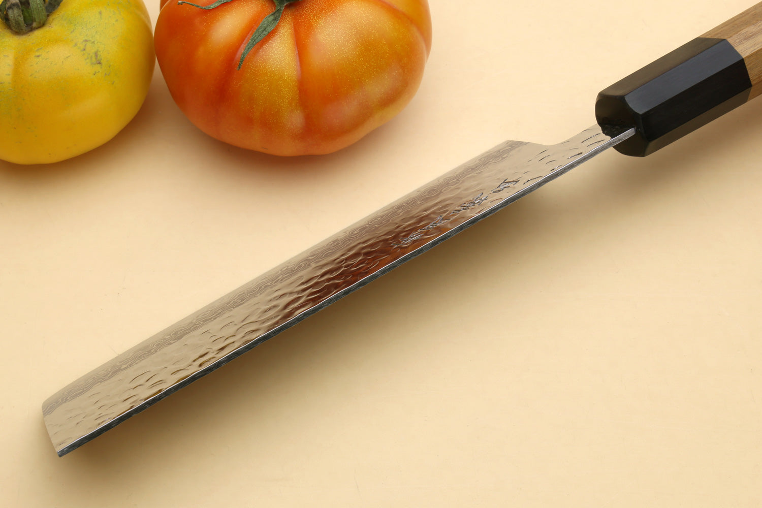 Nakiri vegetable knife side view, silver hammered blade with wood handle and black cap