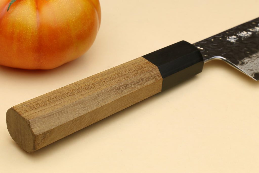 Nakiri vegetable knife handle detail with wood grip, black spacer, and Damascus blade