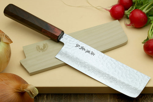 Nakiri vegetable knife at angle with hammered Damascus blade and rosewood handle