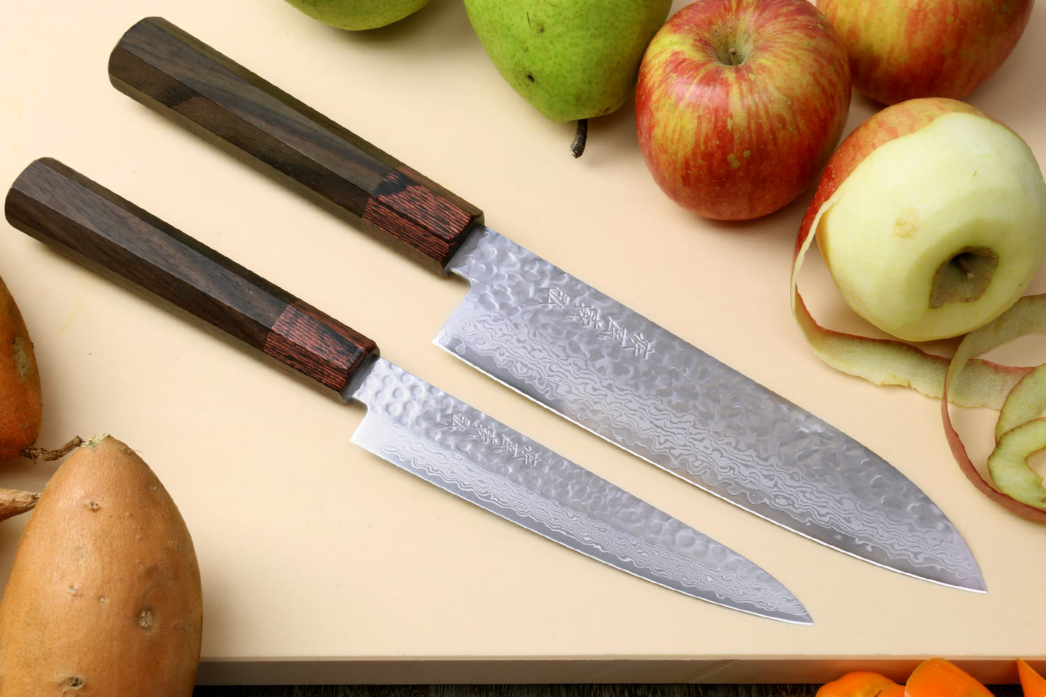 Damascus santoku and petty knives with rosewood handles and hammered blades