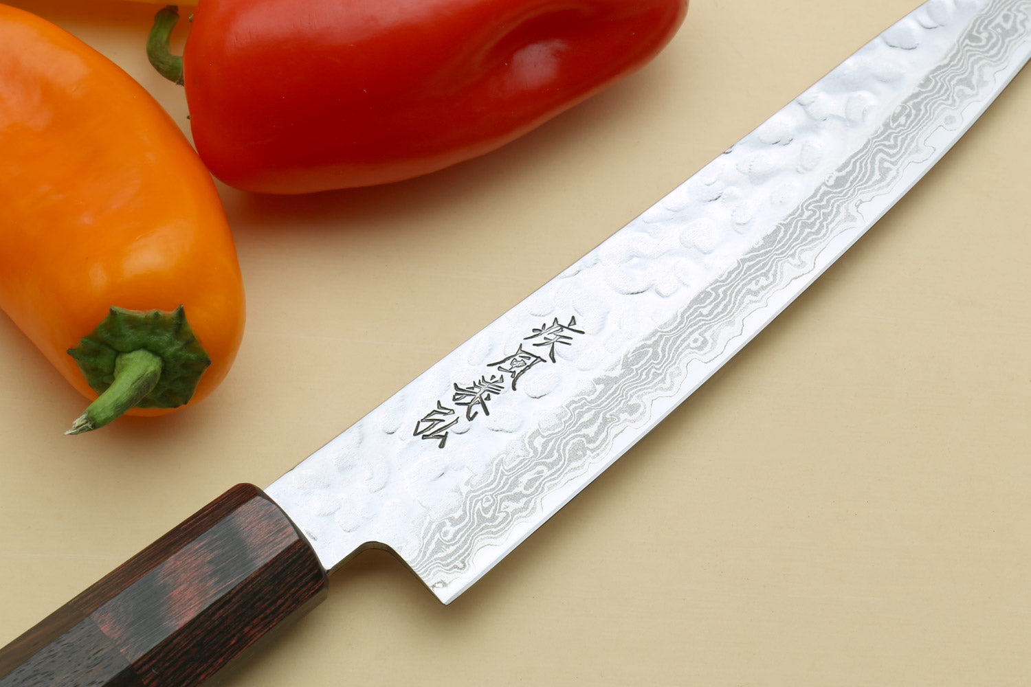 Damascus santoku blade with engraved characters, rosewood handle, hammered finish