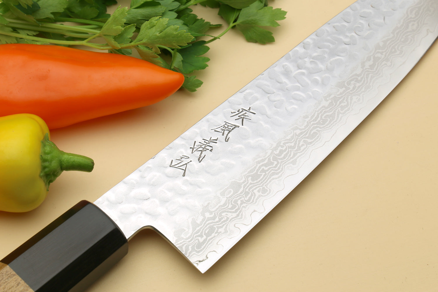 Damascus Santoku chef knife close-up of blade with engraved characters