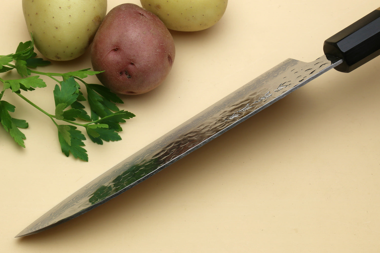 Damascus Santoku chef knife shown from the spine side