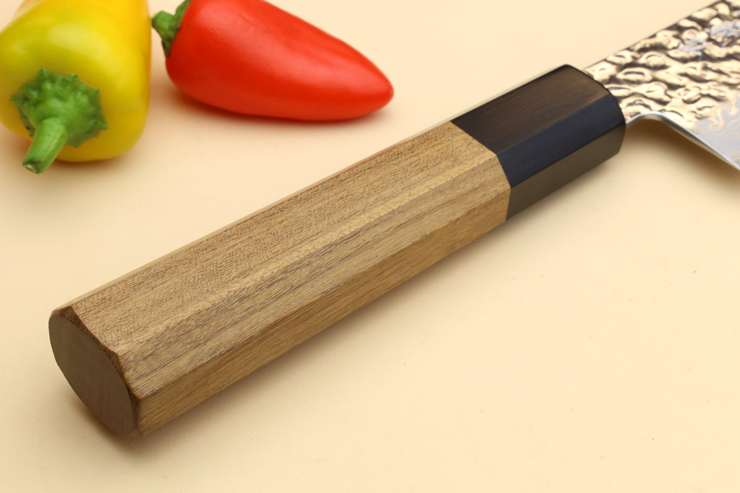 Santoku chef knife handle end with black collar, Damascus blade partly visible