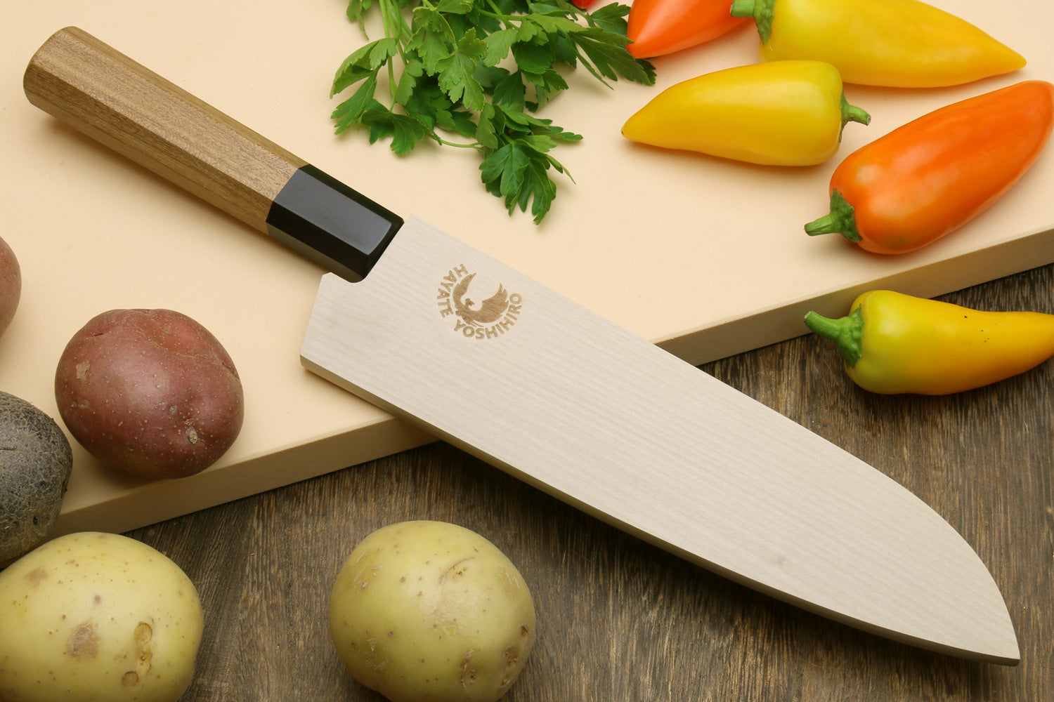 Santoku chef knife with hammered Damascus blade, octagonal wooden handle and black collar