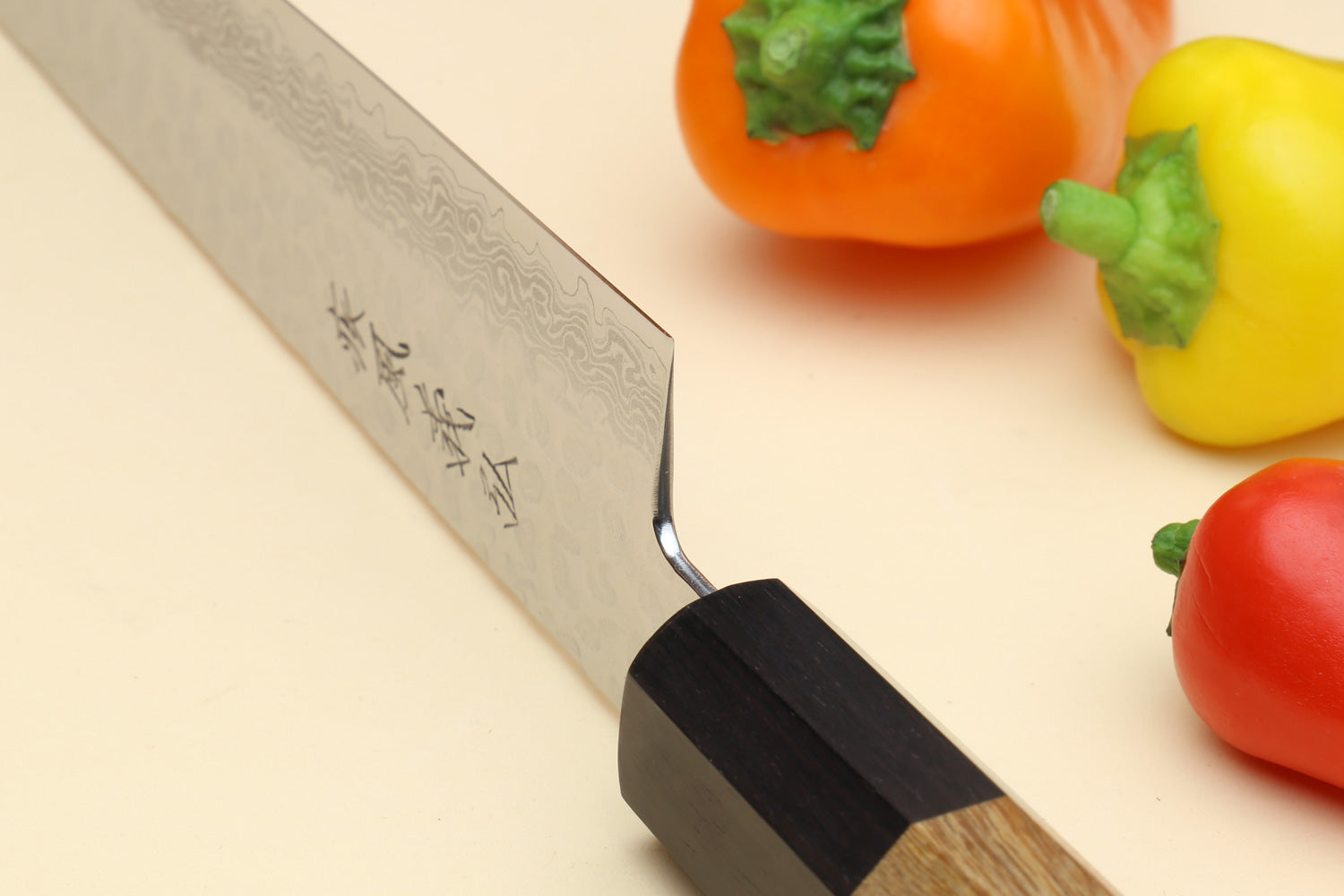 Damascus sujihiki knife with engraved blade markings and octagonal wood handle