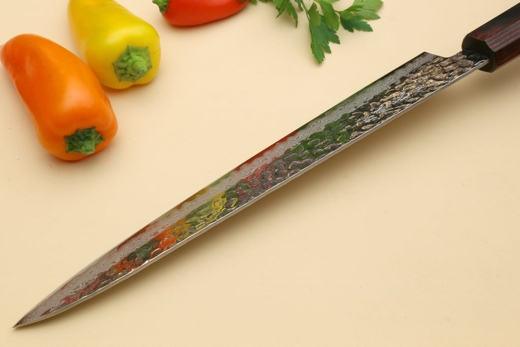 Japanese sujihiki slicer knife with hammered Damascus blade edge and dark rosewood octagonal handle